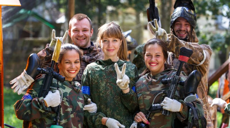 Freunde posieren mit Paintball Waffen im Wald | Paintball Waffen